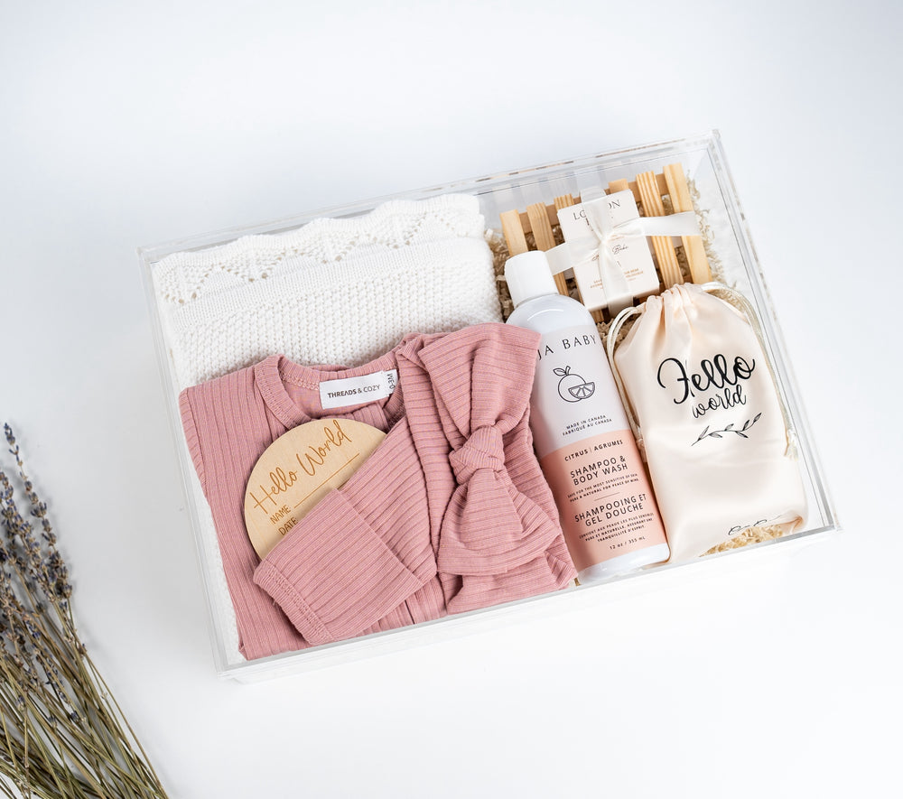 Luxury organic baby gift basket with premium organic sleeper and newborn essentials, elegantly packaged and ready to gift.